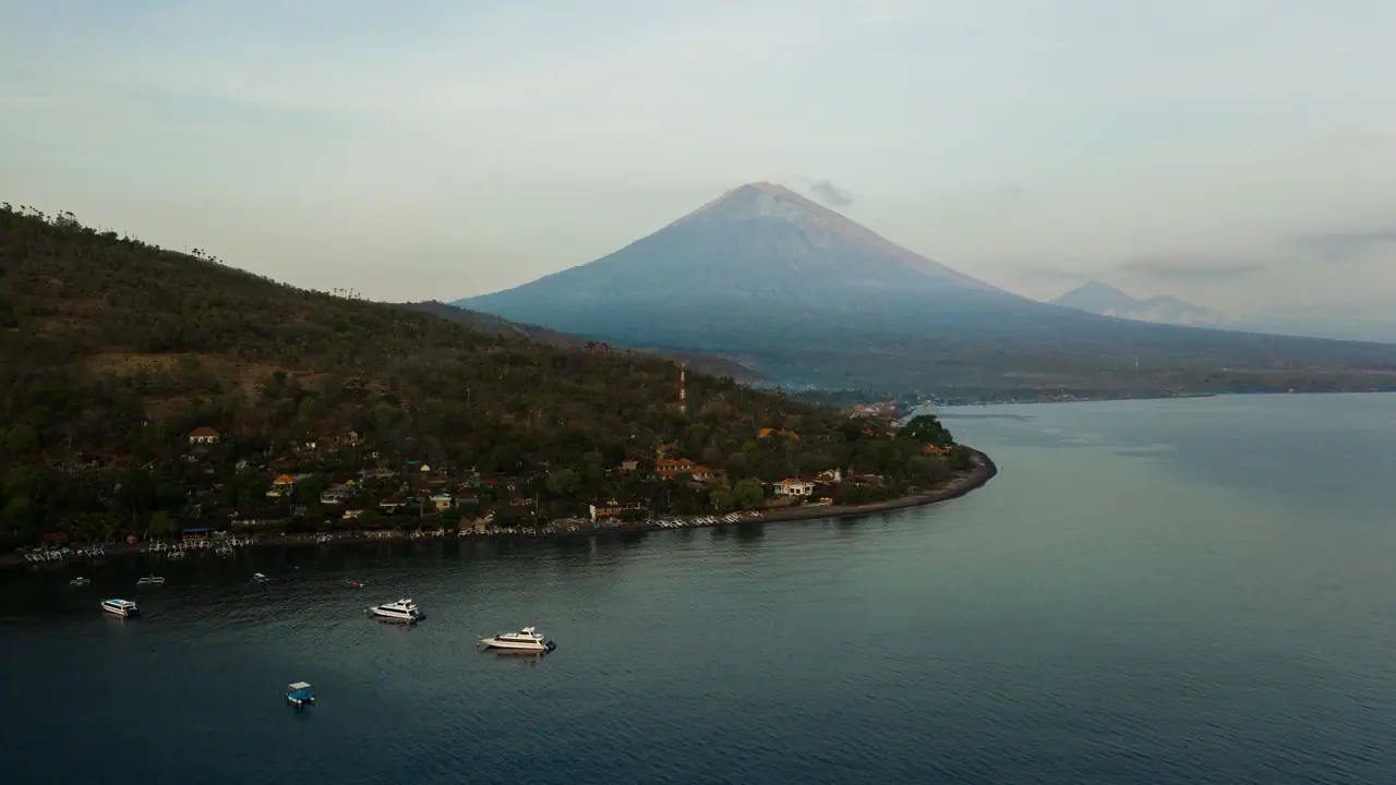 Aerial view of the East Bali coastline with Mount Agung at sunrise