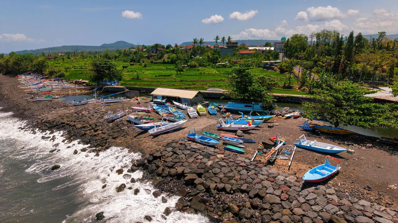Fishing boats pulled up on a rocky shore on the east coast of Bali