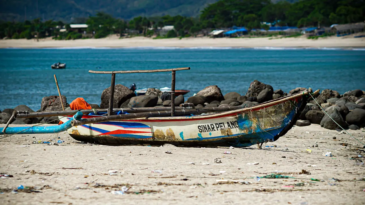 Painted jukung boat resting on the shore