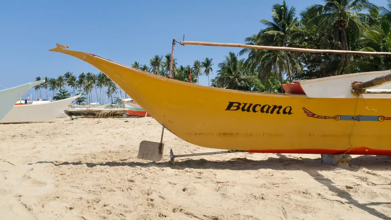Yellow jukung outrigger boat on a sunny Bali beach